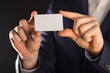 © Aerial Mike - businessman holding blank visit card