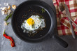 fried eggs iron frying pan rosemary spice pepper
