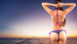 © Mike Orlov - Beautiful woman in sexy bikini over sea background on sunset. Summer advertisement concept with copy space.