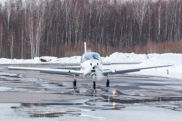 small plane at the airport in winter