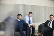 © PhotoAlto - Portrait of businessmen sitting together in the office