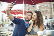 Couple Posing For A Selfie At Outdoor Cafe