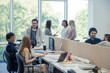 © PhotoAlto - Colleagues chatting in shared coworking space