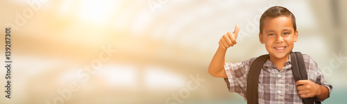 Young Hispanic Male Child Showing Thumbs Up Wearing Backpack with Room For Text.