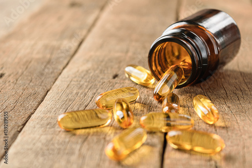 Fotografie, Obraz closeup supplements vitamins bottle on wood background