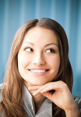 Wall Mural - Portrait of thinkihg smiling business woman at office