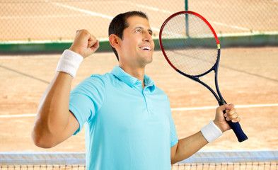 Poster - Portrait of a young male tennis player celebrating a victory on a clay court