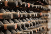 Old Bottles Of Wine In Old Cellar