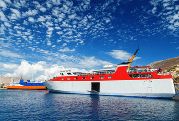 two greek passenger sea ferry of Dodekanisos regular maritime traffic in bay of Simi island at the background of hills and blue sky