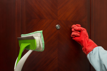 man with brush and glove knocking door concept of domestic cleaning