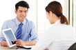 © Tom Wang - young Business people discussing the plan with tablet