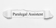 Paralegal Assistent on white torn paper