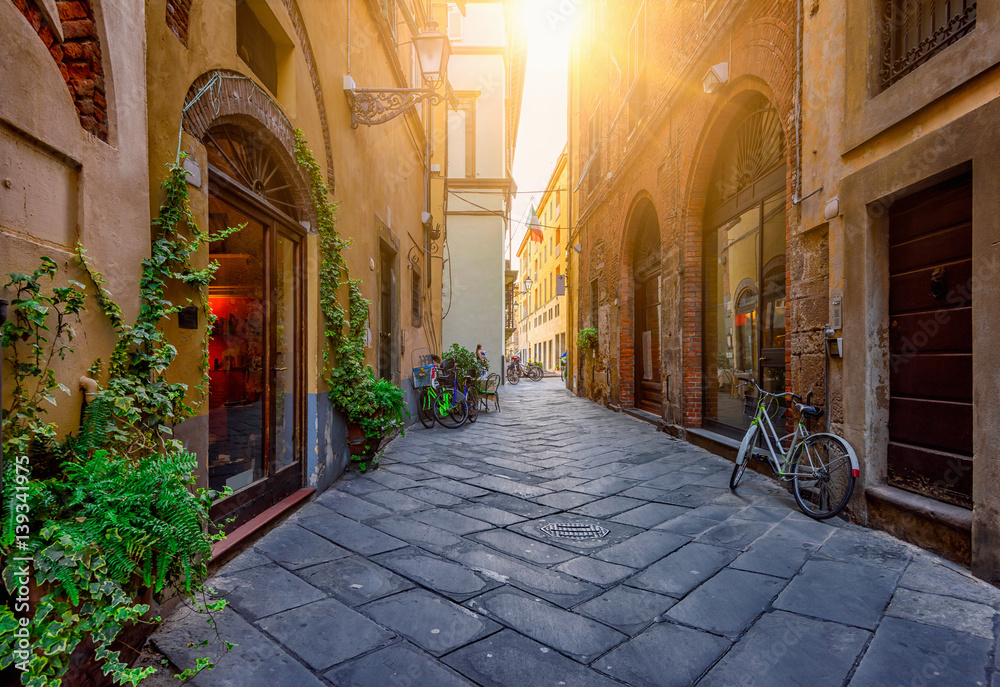 Narrow old cozy street in Lucca, Italy - obrazy, fototapety, plakaty 