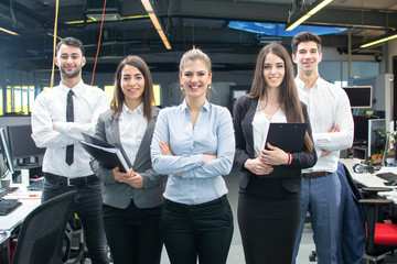 Wall Mural - Group of young business people standing together in office.