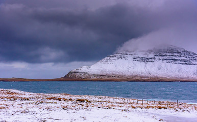 Wall Mural - Storm clouds over the mountains - breathtaking Iceland in winter - amazing landscapes, storms and blizzards - photographers paradise