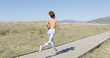 © Dash - Back view of young African woman doing cardio on the beach of Tarifa, Cadiz, Spain.