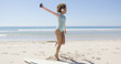 © Dash - Female listening to music wearing light blue swimsuit and headphones on beach. Tarifa beach. Provincia Cadiz. Spain.