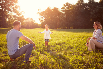 Wall Mural - Father with daughter playing ball outdoor