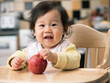 © M-image - baby girl eating apple