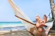 © Song_about_summer - happy couple family in hammock on tropical paradise beach, island holidays, closeup of feet