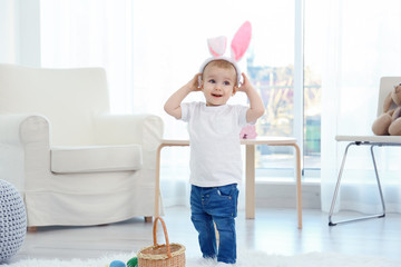 Sticker - Cute little child in bunny ears standing at home