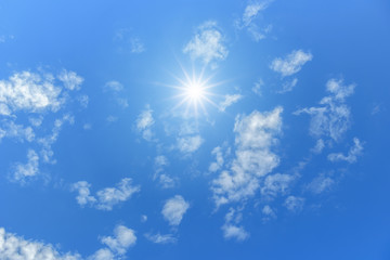 Wall Mural - blue sky with clouds and sun reflection. looking up view