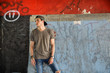 © theartofphoto - Attractive young man standing against colorful wall, looking away