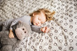 © Denira - Little girl sleeping with a toy on the bed