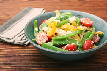 Wall Mural - Snow pea salad with feta, tomato and pepper