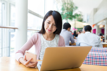 Poster - Woman using cellphone and laptop computer