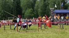 Medieval Joust With Knights On A Hors In Armour And Costume. Battle With Spear On Stadium Summer Time.