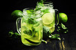 Green tea with mint and ice, black background, selective focus