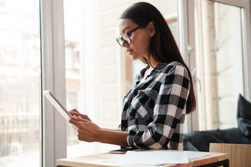 Sticker - Amazing young caucasian woman using tablet computer