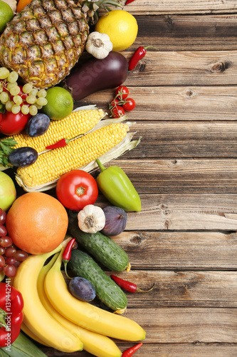 Naklejka dekoracyjna Ripe fruits and vegetables on wooden table