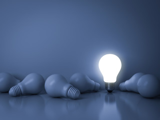 Fototapete - One glowing light bulb standing out from the unlit incandescent bulbs on blue background with reflection , individuality and different creative idea business concepts . 3D rendering.