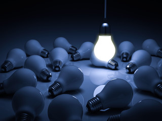 Poster - One glowing hanging light bulb standing out from the unlit dead incandescent bulbs with reflection , leadership and different business creative idea concept. 3D rendering.