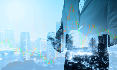 Poster - Double exposure of Business man working with a digital tablet with cityscape blurred building background,investment, success and profitable business concepts