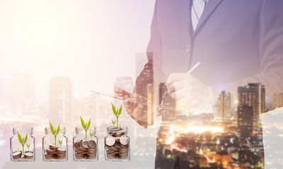 Poster - Double exposure of Business man working with a digital tablet with cityscape blurred building background,investment, success and profitable business concepts