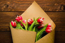 Bouquet Of Tulips In Kraft Paper. Red White Tulips On Wooden Boards.