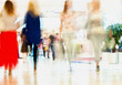 Abstract defocused motion blurred people, walking girlfriends in the shopping center, urban lifestyle concept, background.