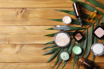 Wall Mural - Set of cosmetics products and leaf on wooden table