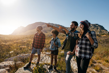 Wall Mural - young people hiking on extreme terrain
