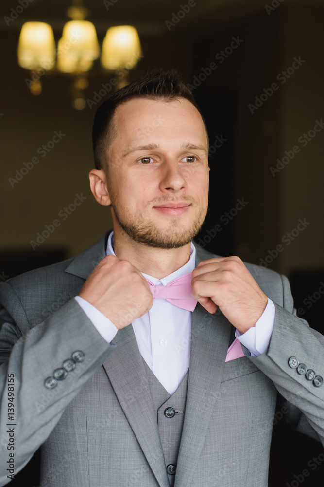 white dress shirt with pink bow tie Grey Pants White Shirt Pink Bow Tie Elegant Young Fashion Man Dressing Up  For Wedding Celebration