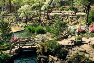 A bridge over a stream, pond, flowering Park Old Mill, the city of Little Rock, Arkansas, USA