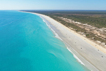 Aerial view of cars dotted along the wide expanse of Cable Beach, Broome, Western Australia