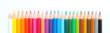 Colored Pencils Row With Wave On White Background