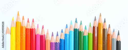 Fotografía colored pencils row with wave on white background