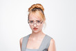 Young nice woman in glasses worried, upset and perplexed of problem. Unsolved situation, inability to concentrate, failure. Portrait on grey background.
