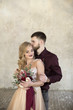 © Vil Karimov - bride and groom pose near window and  wall