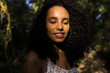 © Eva - portrait outdoors of a beautiful young afro american woman at sunset. Black background. Lifestyle